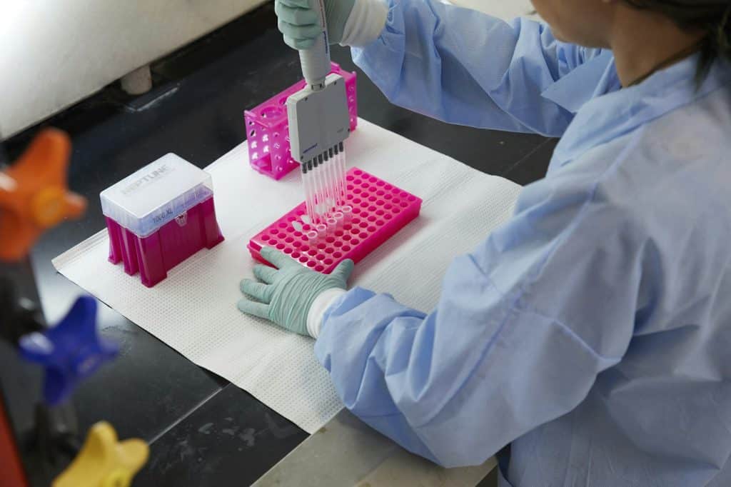 Tools and containers in a medical lab, work being done with pipette and samples